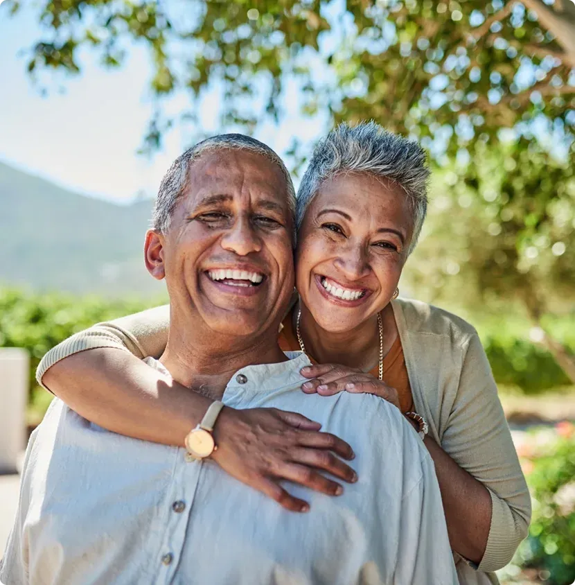 A senior couple embracing outdoors