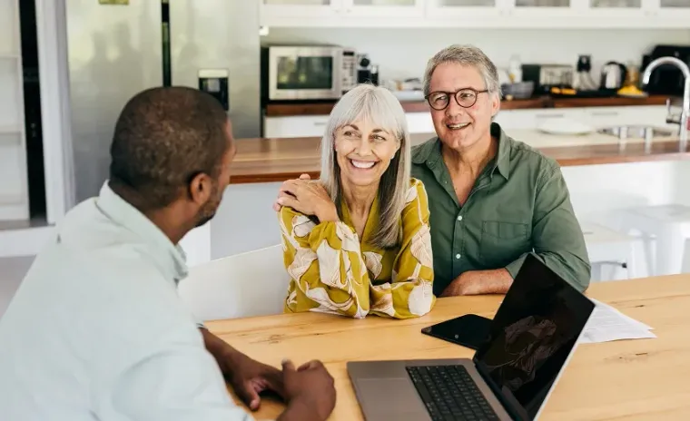 Smiling couple discussing with a consultant