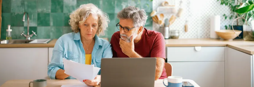 Mature couple reviewing paperwork together