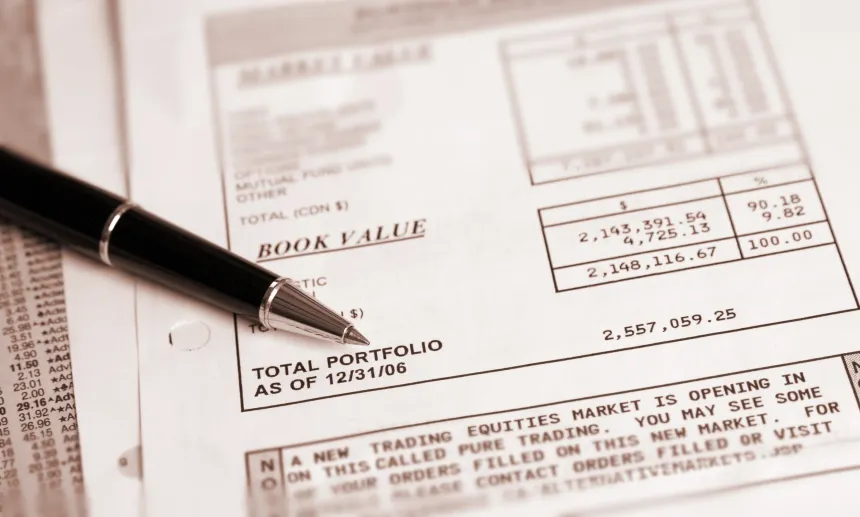 Hands reviewing portfolio charts at a table