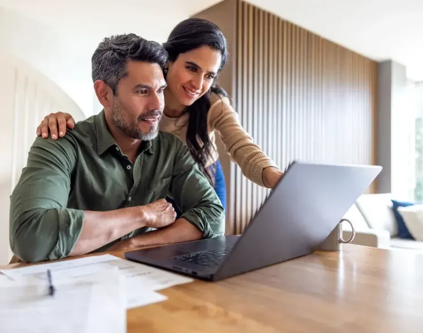 A couple at a laptop, working through their options together
