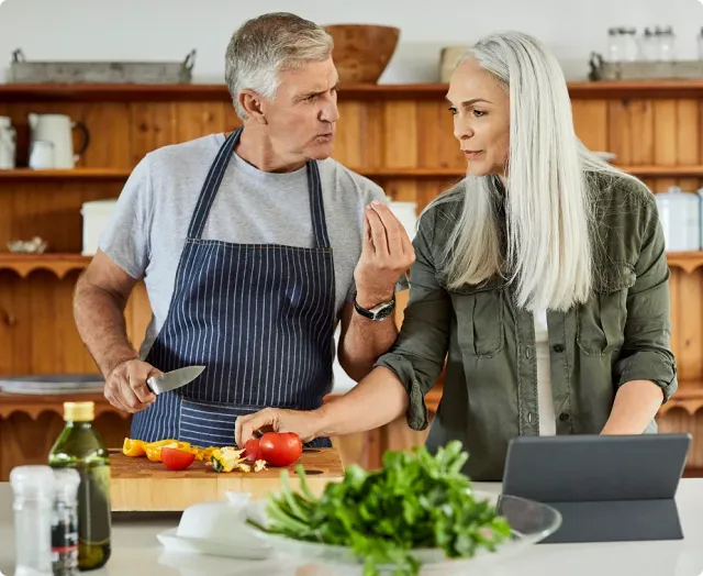 A couple cooking together in their kitchen